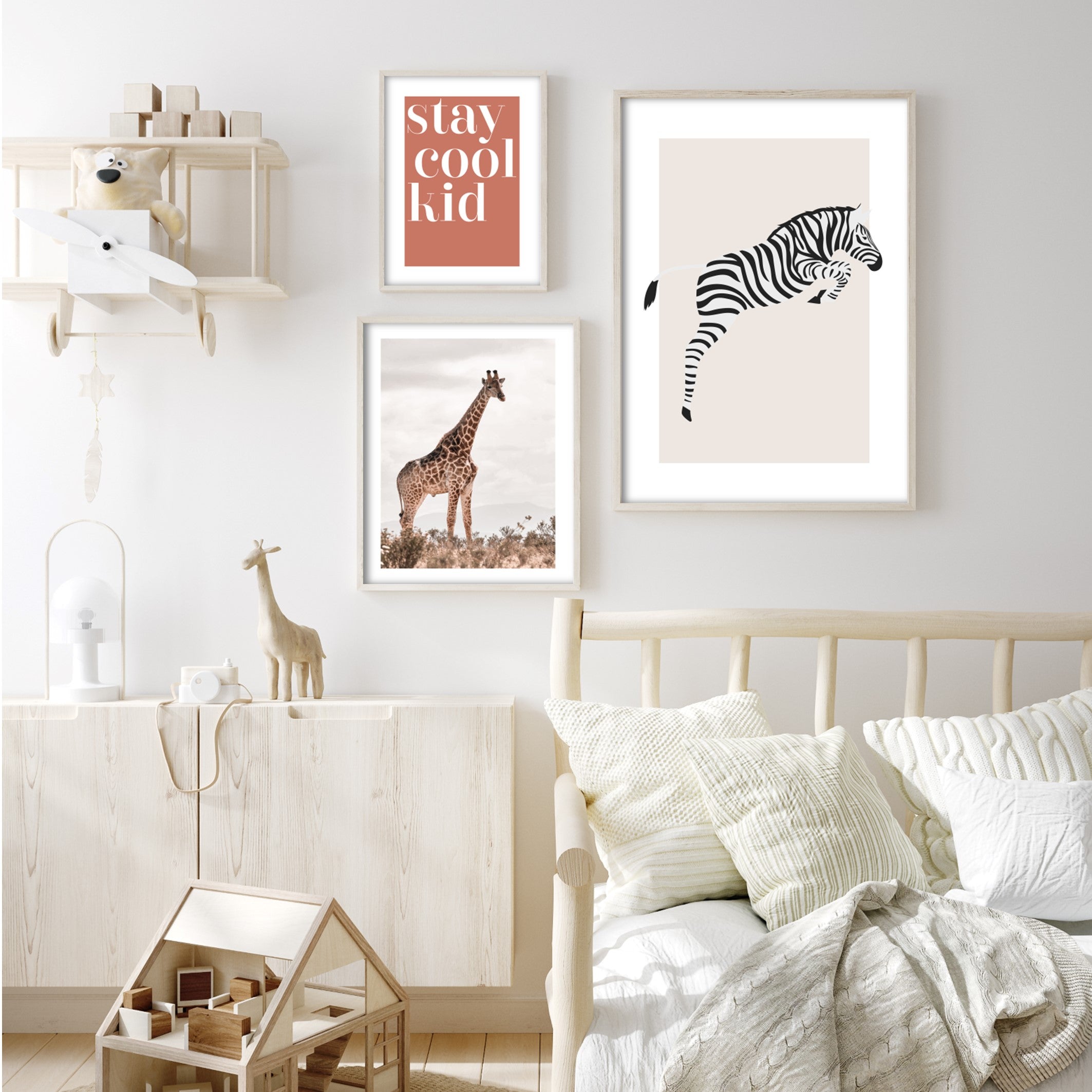 Photography of Giraffe in a field of short bushes with cloud white skies print in cream decorated childs bedroom