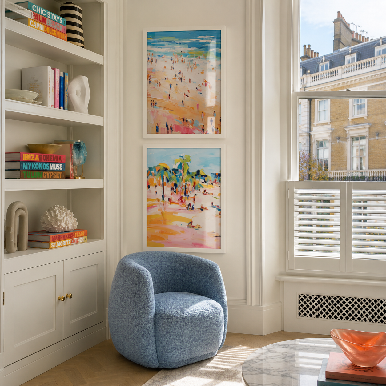 Modern living room with a blue armchair, bookshelf, and colorful artwork.