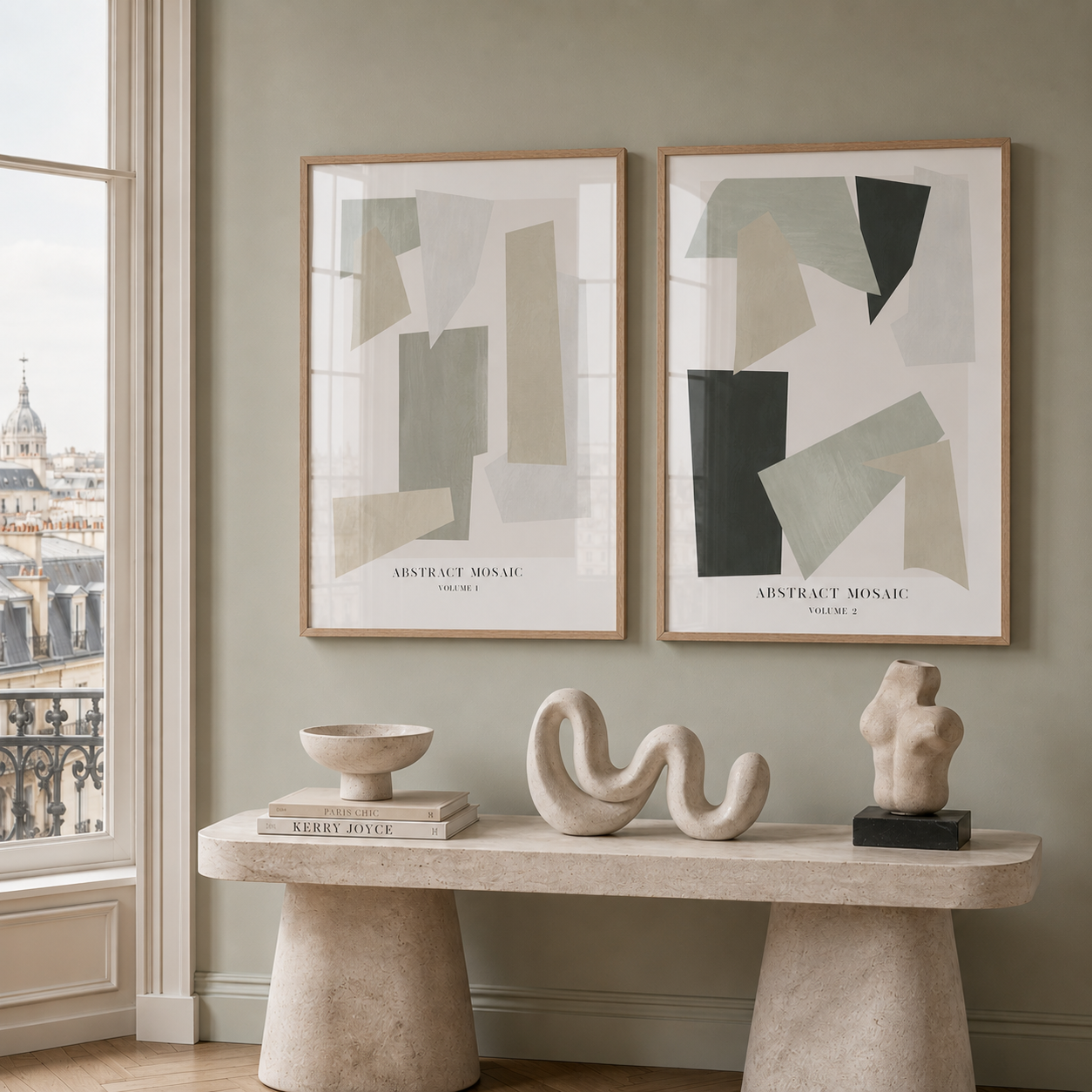 Two abstract art pieces on a wall above a stone console table with decorative items.