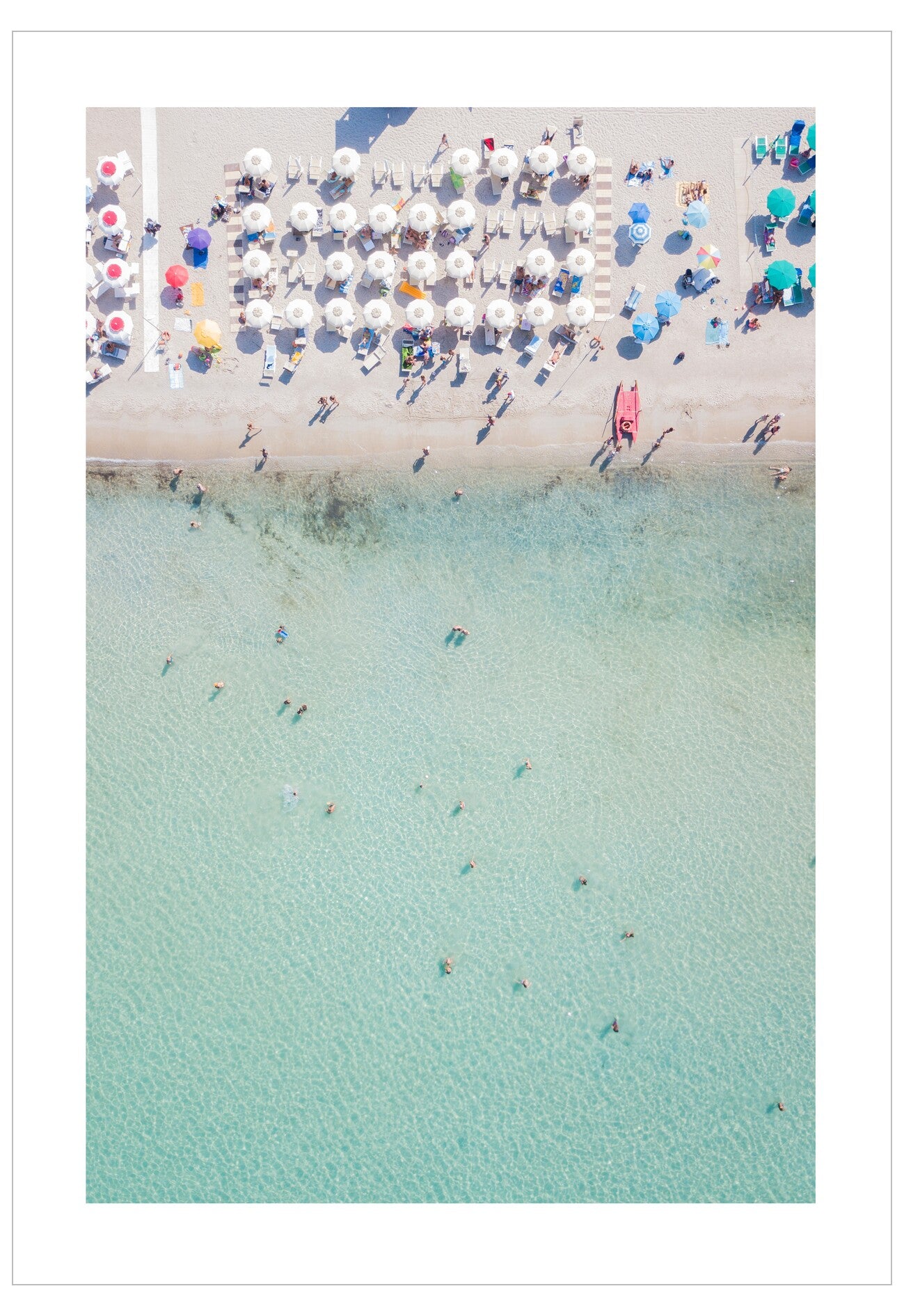 Beach scene with people, umbrellas, and clear water