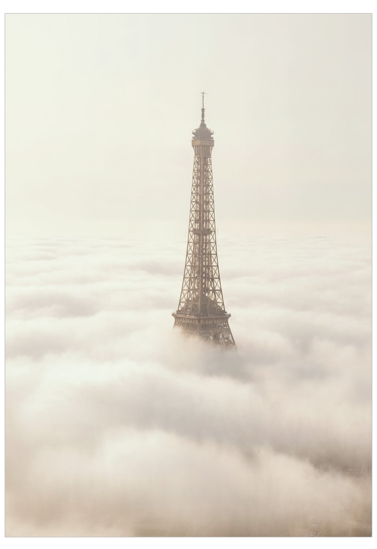 Eiffel Tower emerging from a sea of clouds
