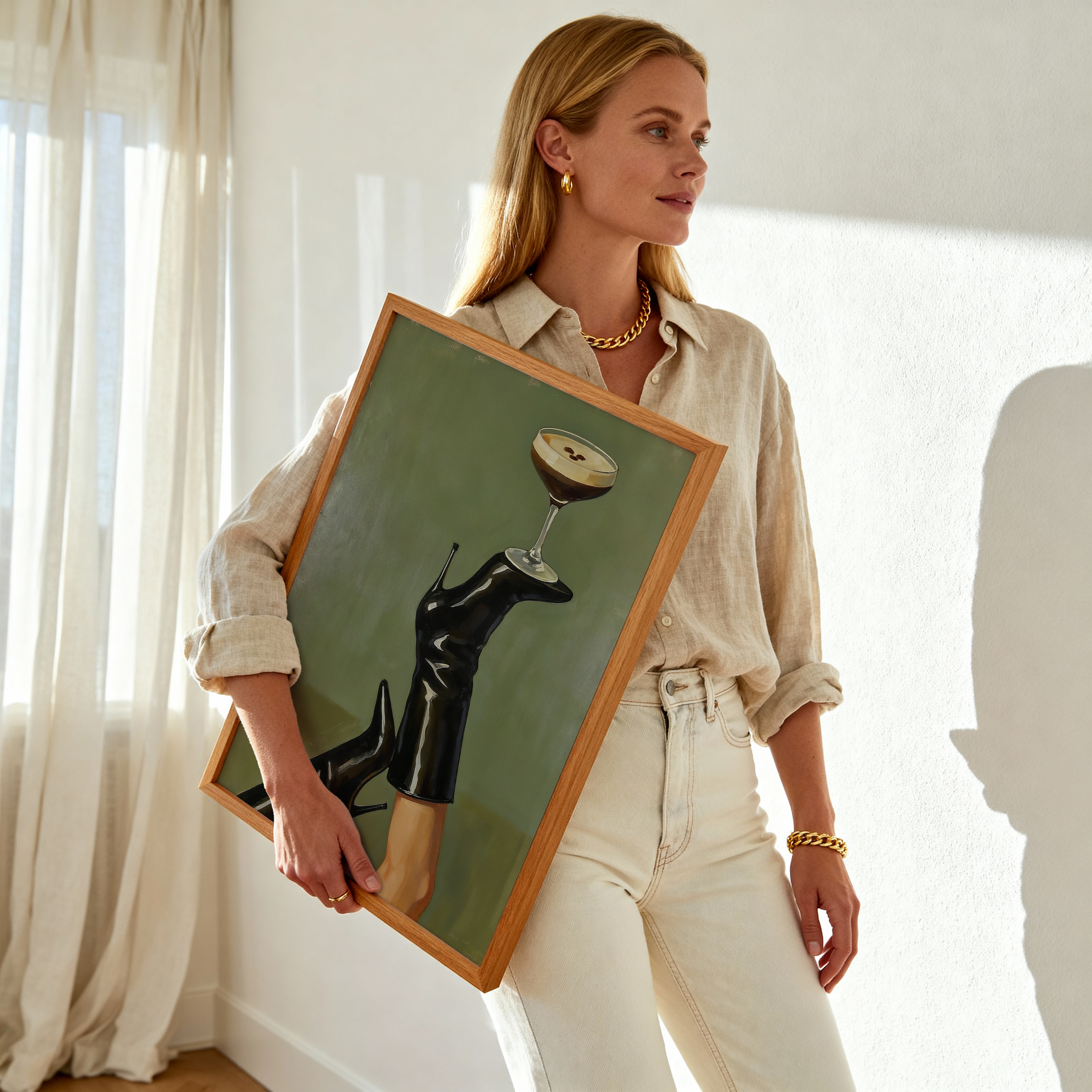 Woman holding a framed artwork of black shoes and a glass.