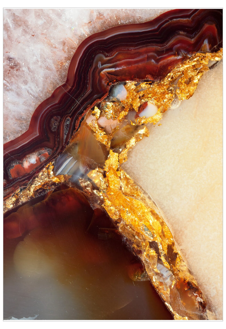 Close-up of a colorful agate stone with gold and red patterns.