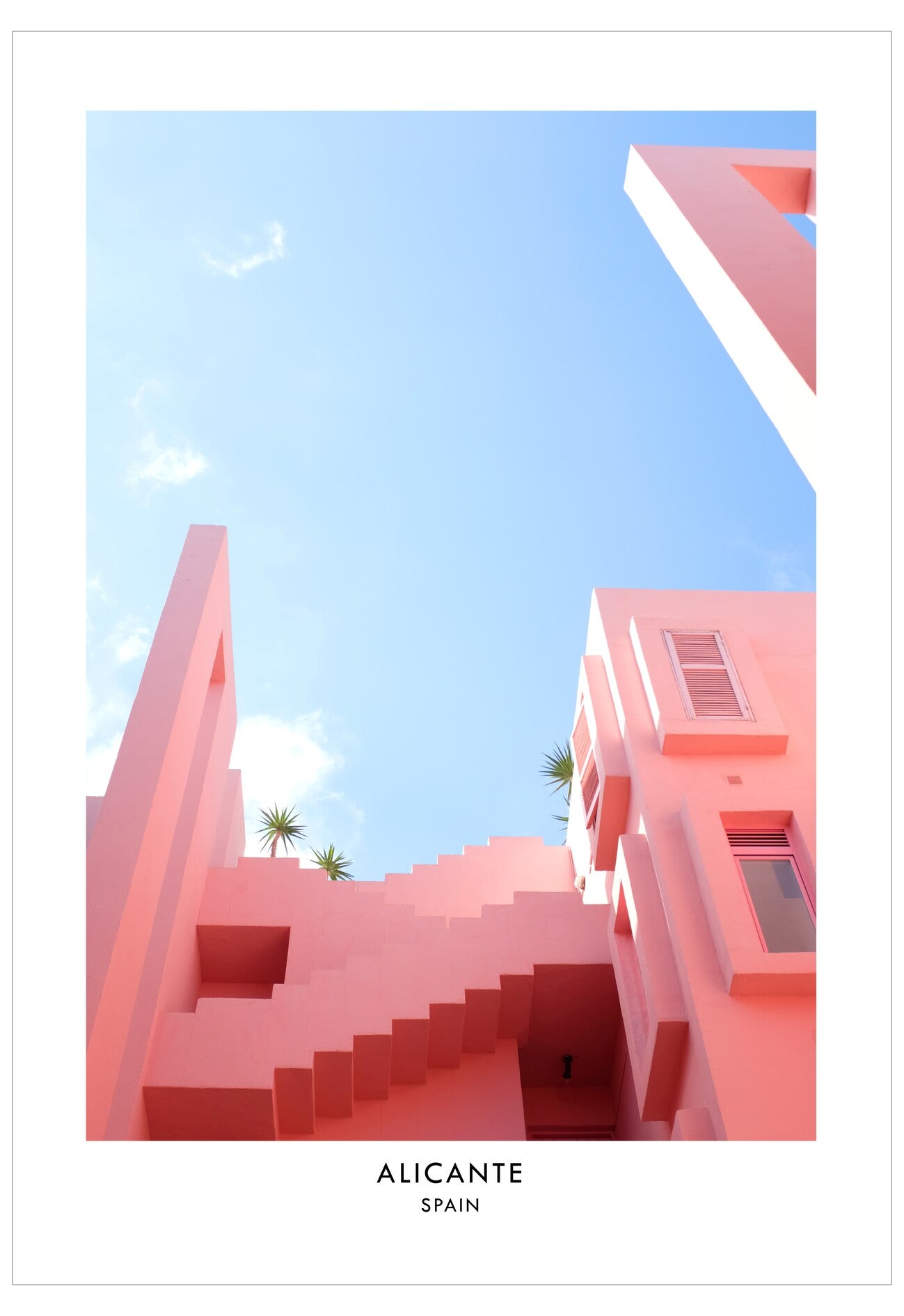 Pink architectural buildings in Alicante, Spain with a clear blue sky.