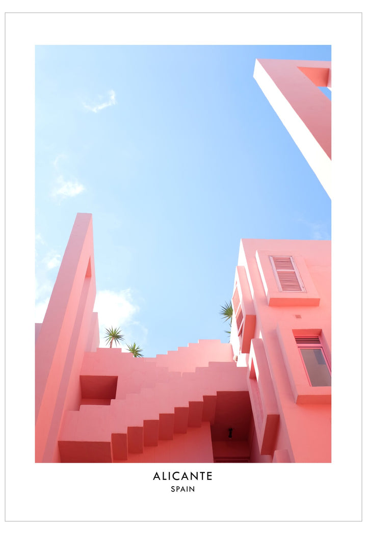 Pink architectural buildings in Alicante, Spain with a clear blue sky.