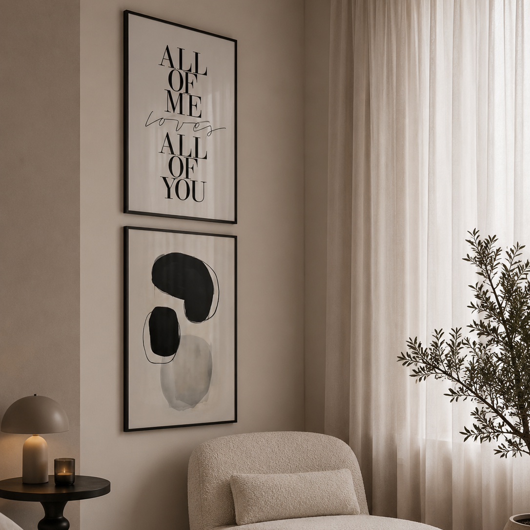 Modern bedroom with a chaise lounge, framed art, and a plant.