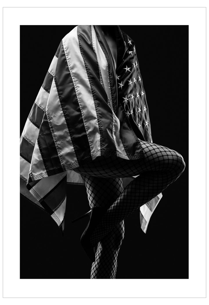 Person wearing a flag-patterned jacket on a black background