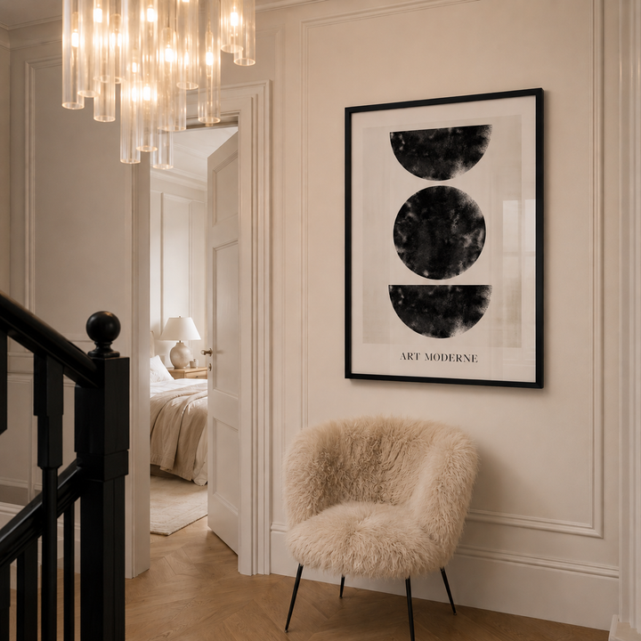Modern interior with a fluffy chair, framed art, and chandelier.