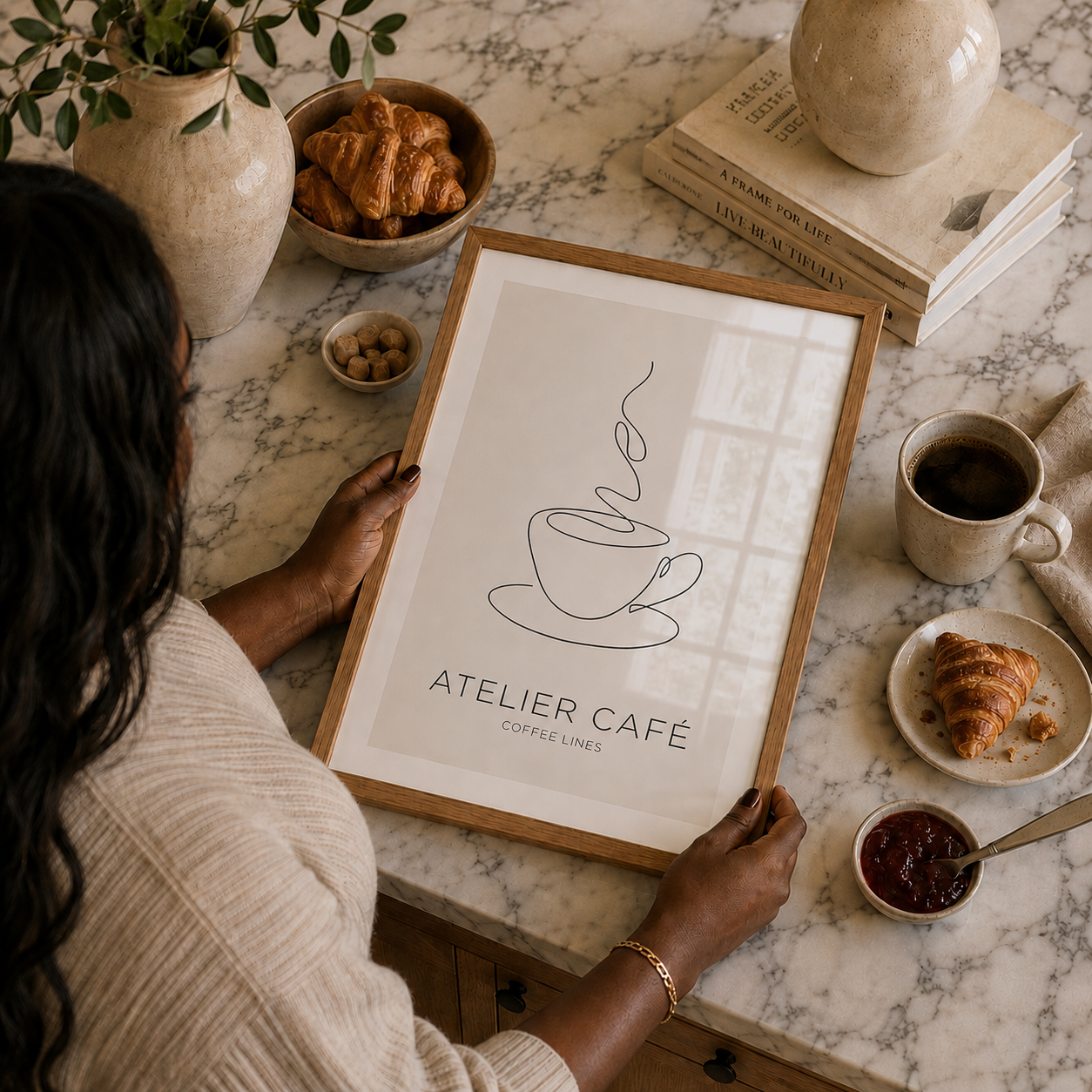 woman holding a stylish oak framed coffee art print in a luxury kitchen