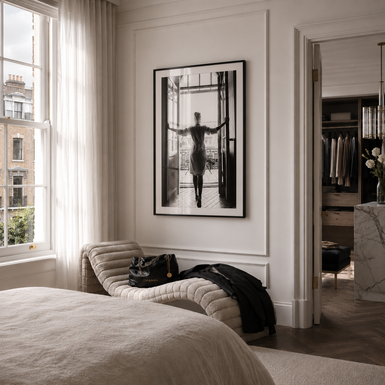 Modern bedroom with a bed, window, and framed artwork on the wall.