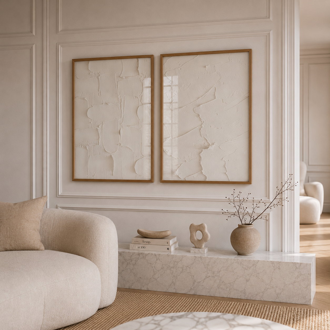 Modern living room with beige armchair, abstract art, and decorative items.