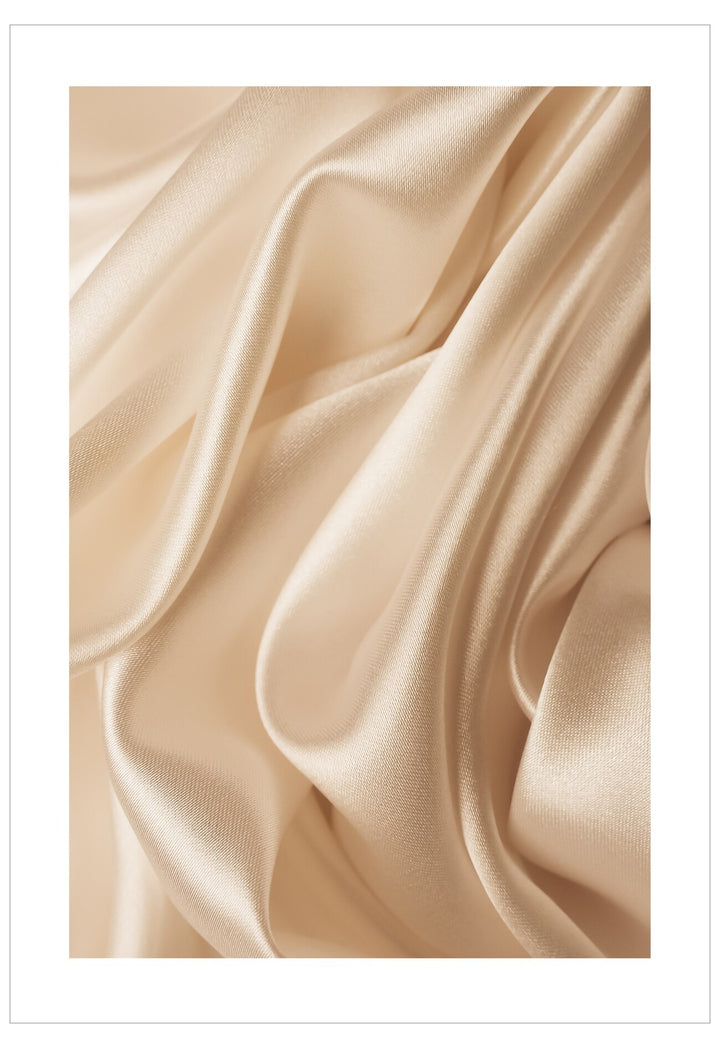 Close-up of beige satin fabric with soft folds