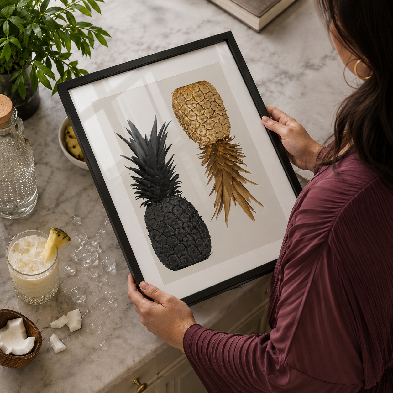 black and gold pineapple art in a black wooden frame in a luxury kitchen 