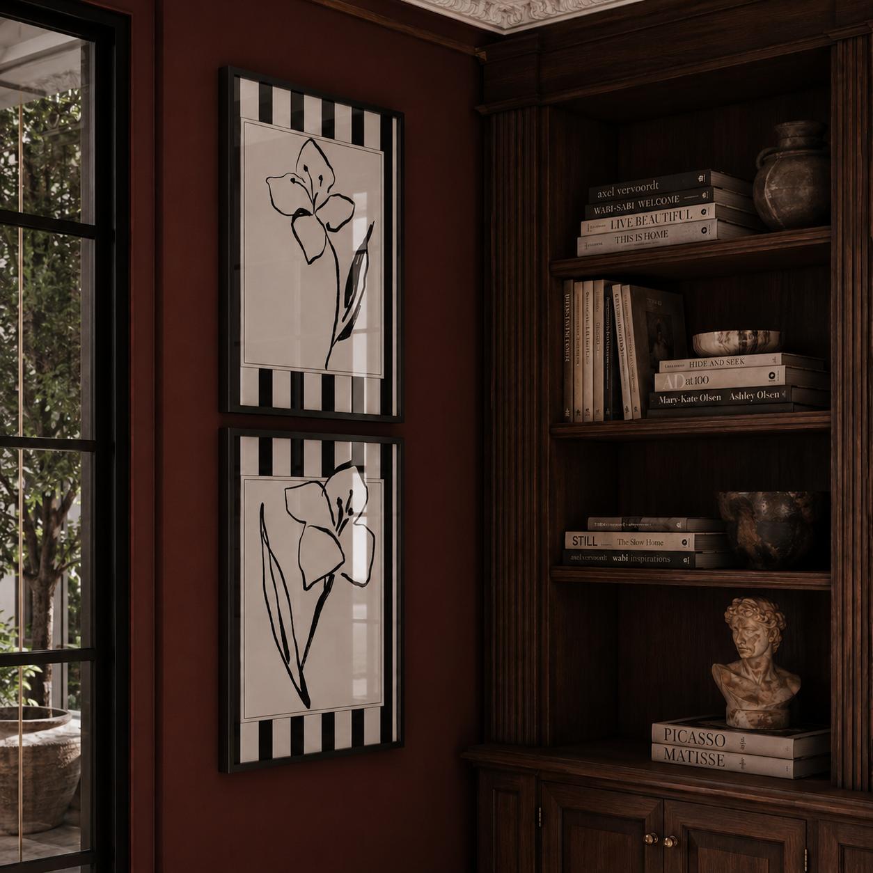 Decorative wall art with floral design on a wall next to a bookshelf.
