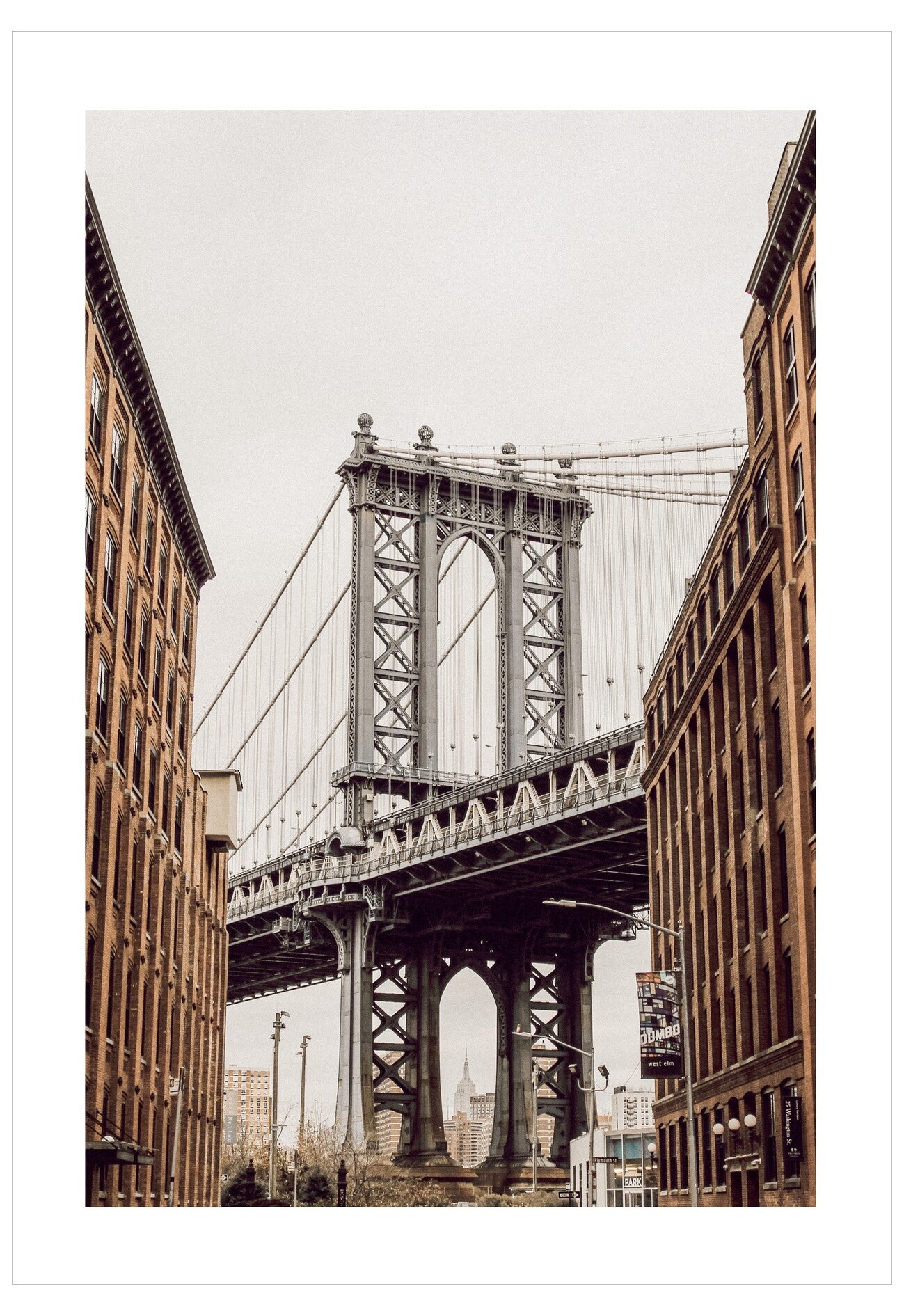 Manhattan Bridge viewed from between two buildings in a cityscape