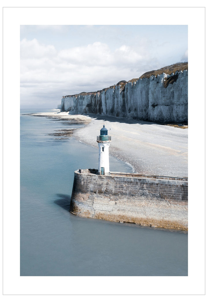 Lighthouse on a pier with cliffs and ocean in the background