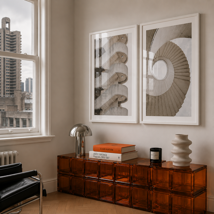 Modern interior with a wooden side table, books, and decorative items near a window with cityscape view.