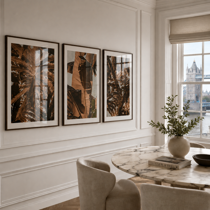 Elegant interior with framed artwork on a wall and a marble table with decor.