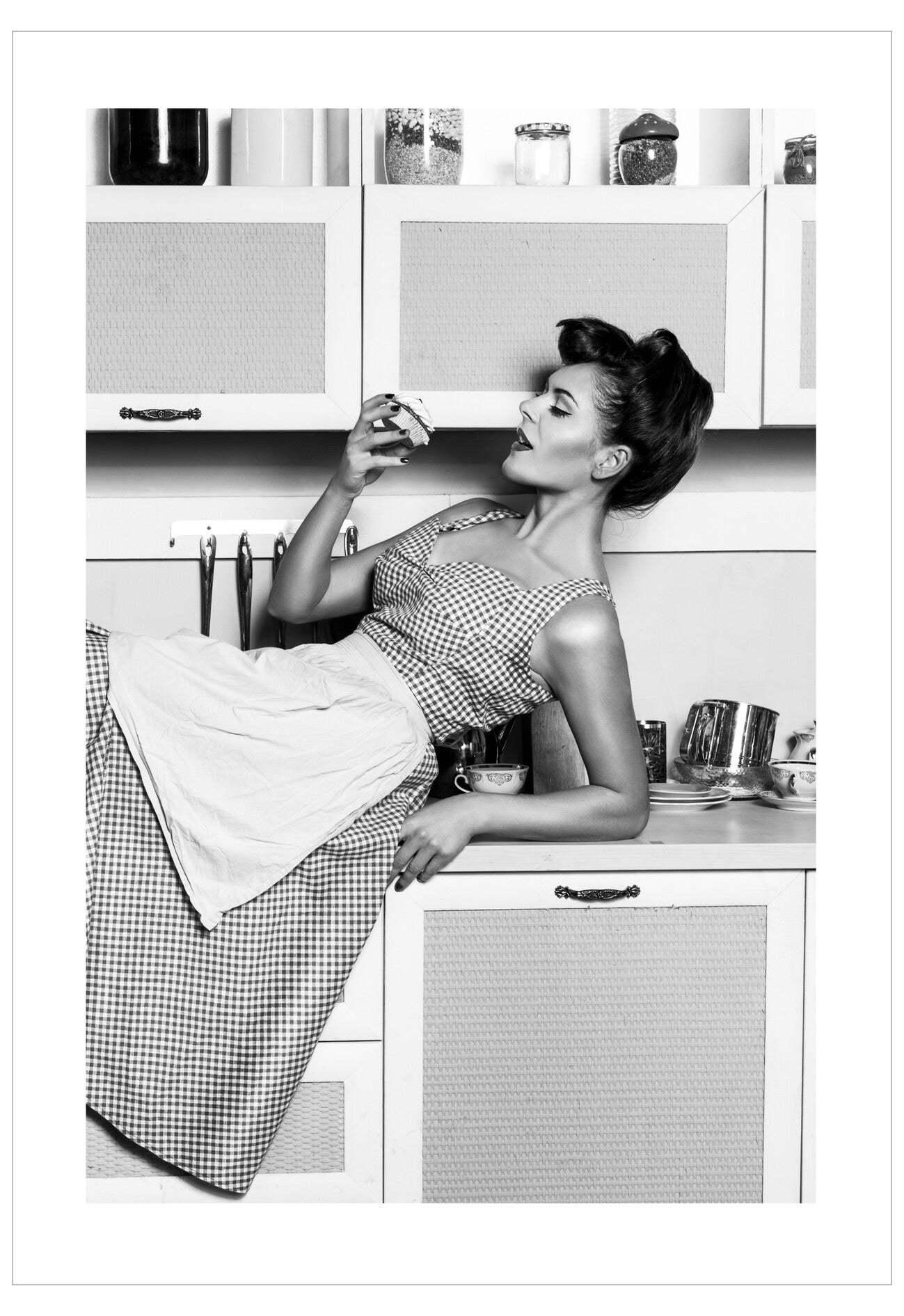 Black and white photo of a woman in a kitchen