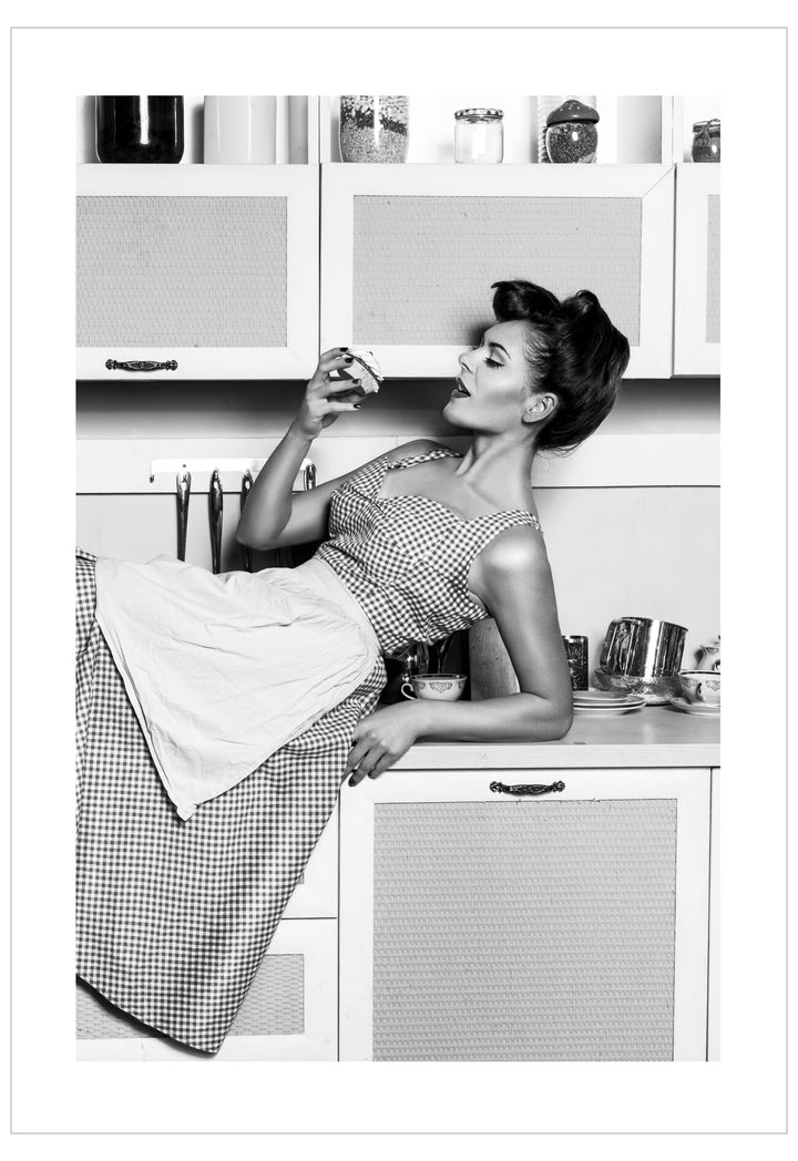 Black and white photo of a woman in a kitchen