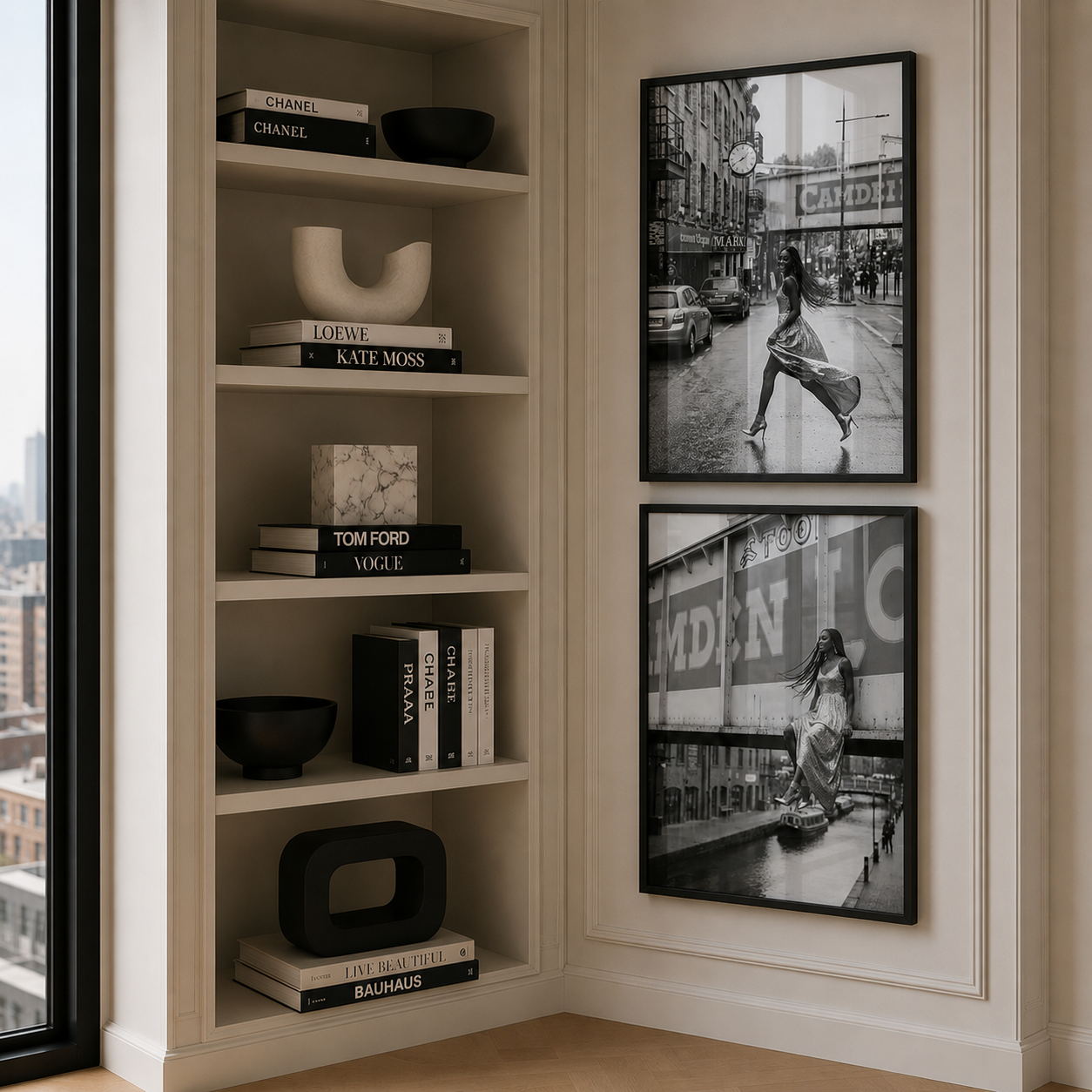 Bookshelf with decorative items and framed black and white photos on a wall.