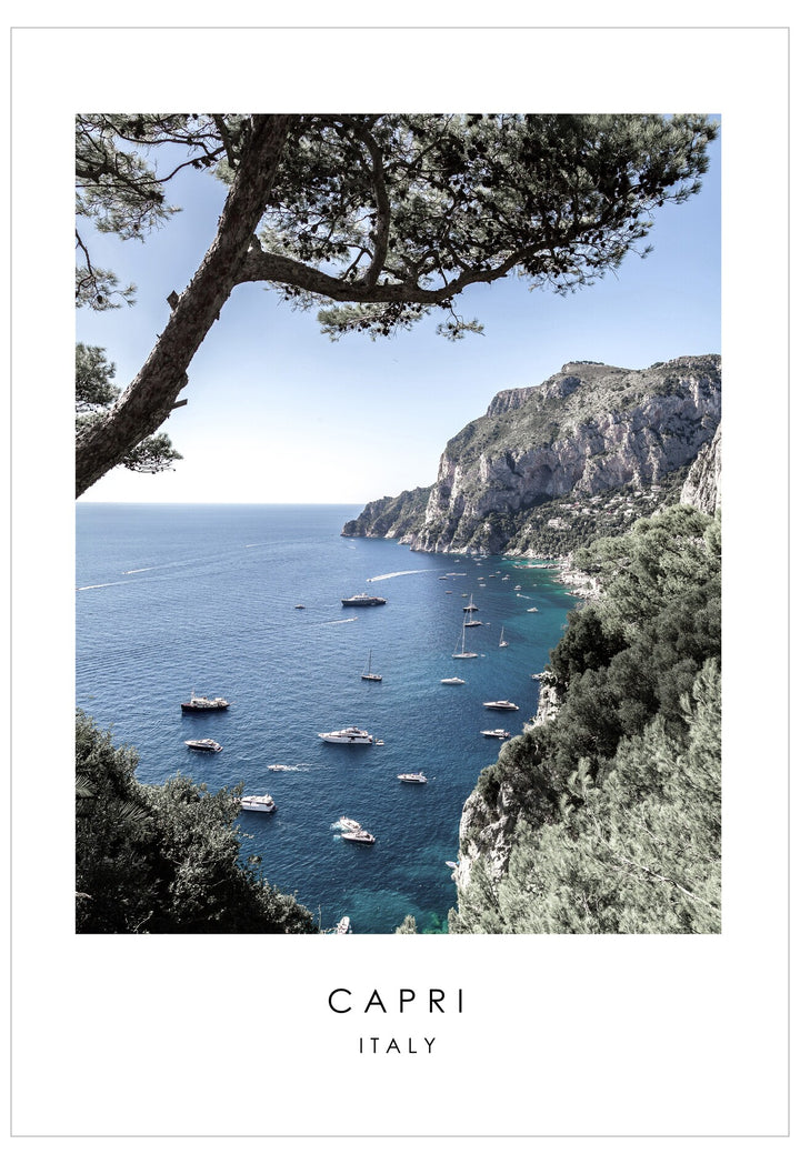Scenic view of Capri with boats on the water and rocky cliffs.