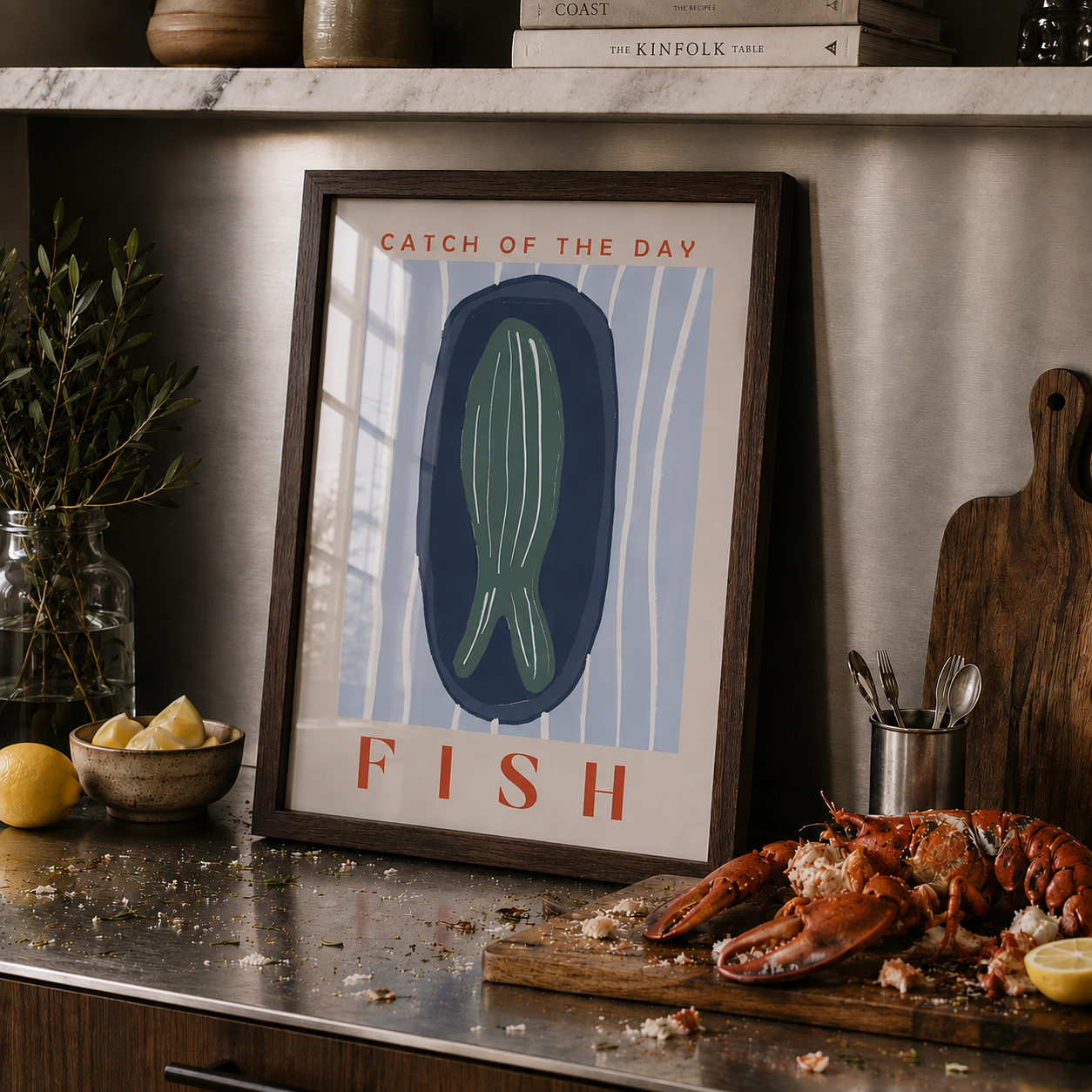 Framed artwork with 'Catch of the Day' and 'Fish' text on a kitchen counter with a lobster.