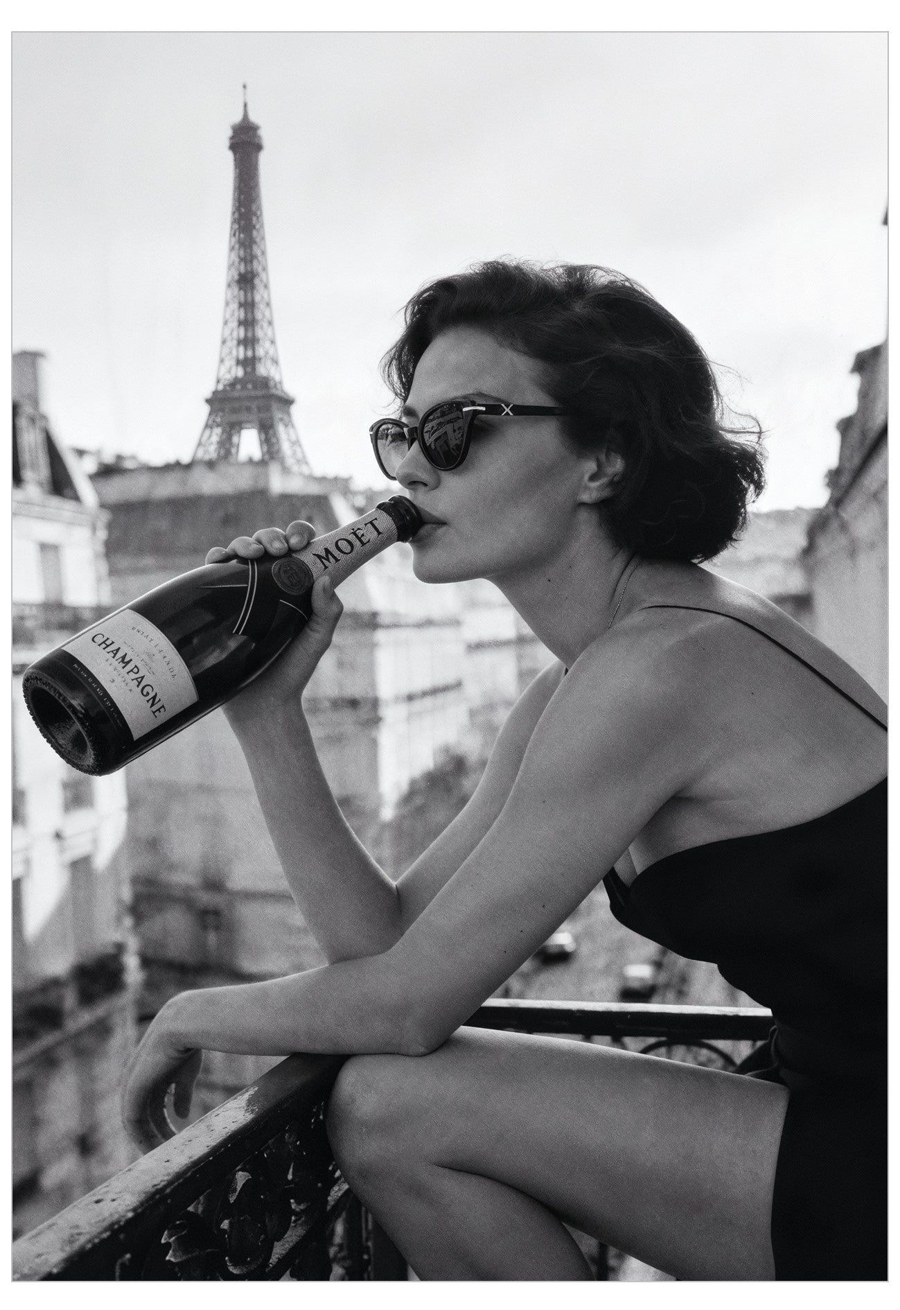 Woman drinking Moet champagne with the Eiffel Tower in the background