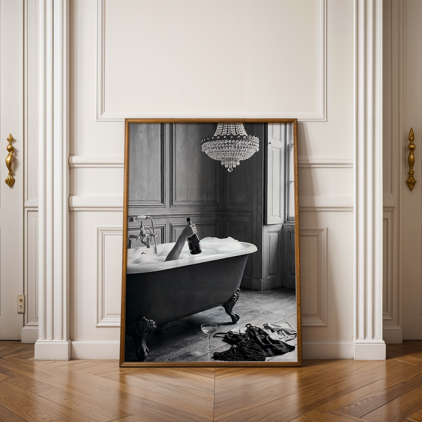 Framed black and white artwork of people on surfboards in a room with wooden floor and white walls.