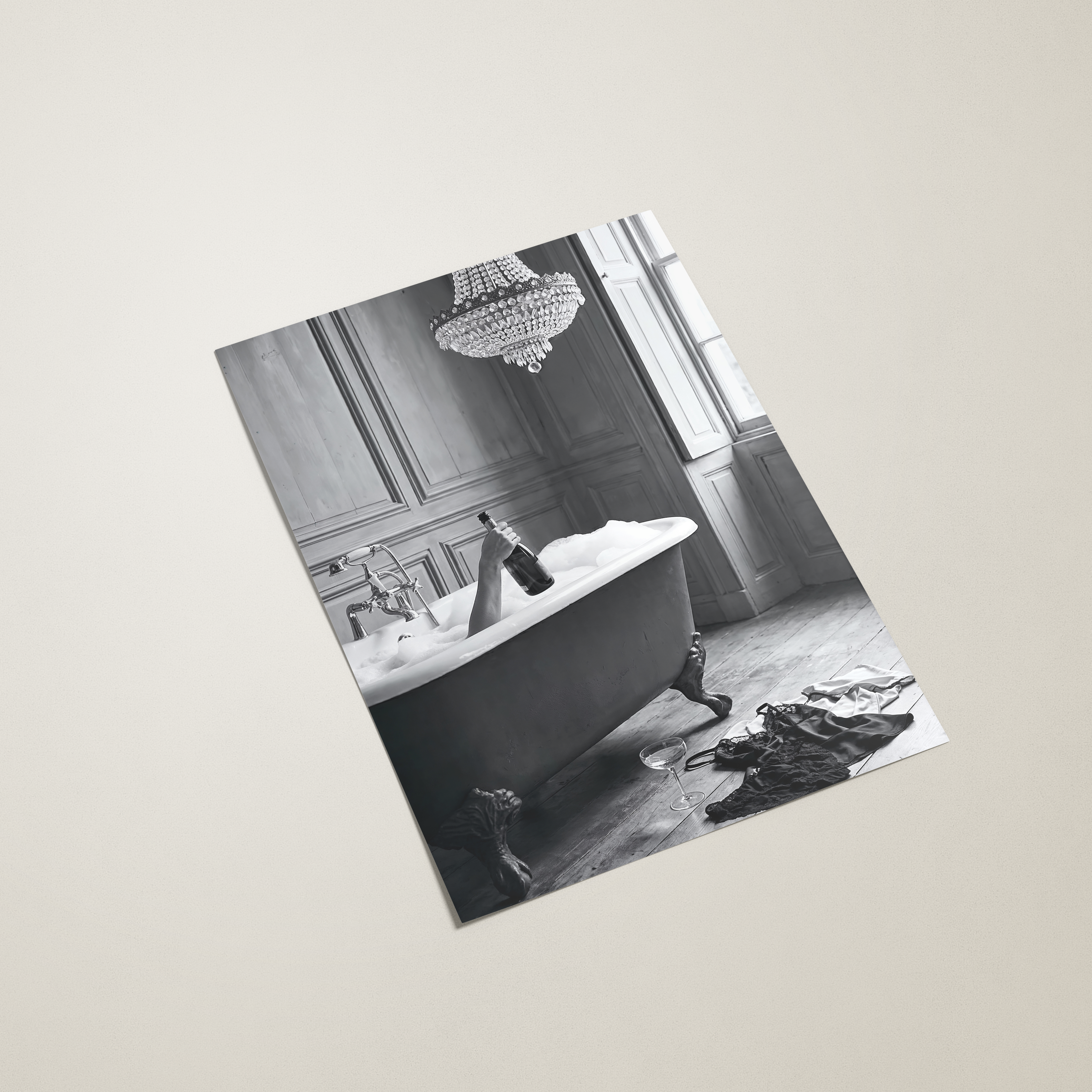 Black and white photo of a bathroom with a freestanding bathtub on a beige background