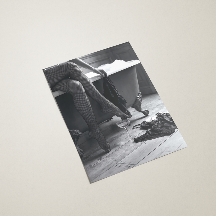 Black and white photo of a roll top bath on a beige background