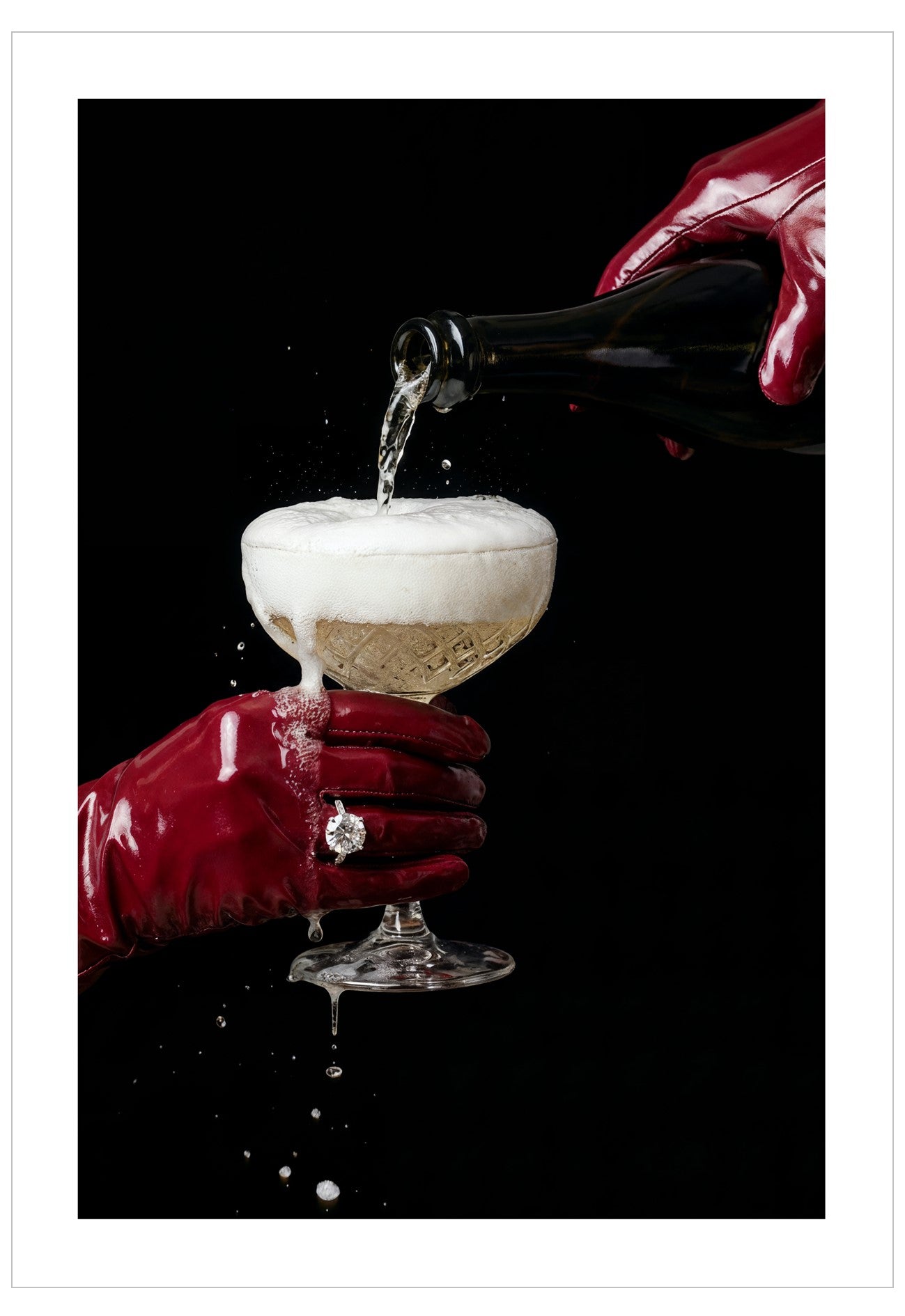 Person in red gloves pouring a drink into a glass with a black background