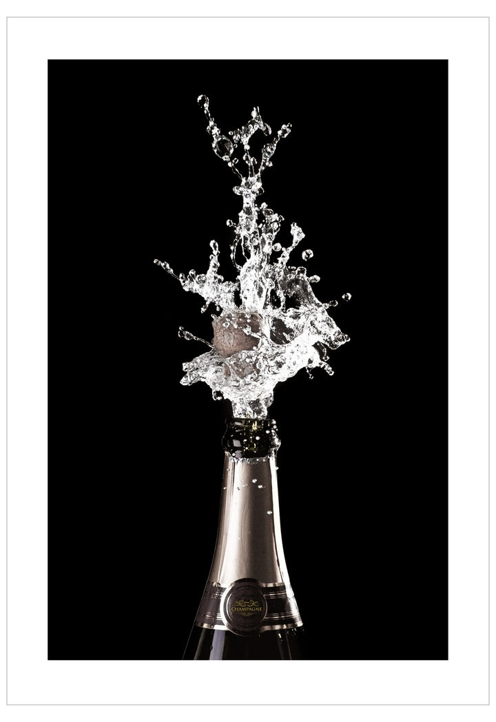 Champagne bottle with a dramatic splash against a black background