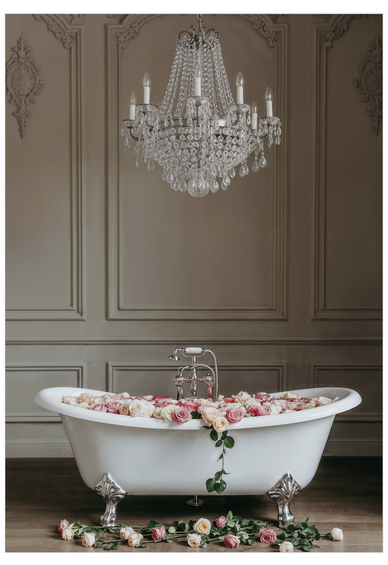 White freestanding bathtub with flowers in a room with a chandelier.