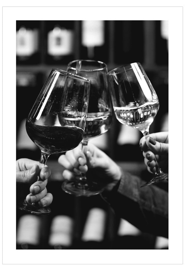 Three wine glasses being clinked together in a celebratory gesture.