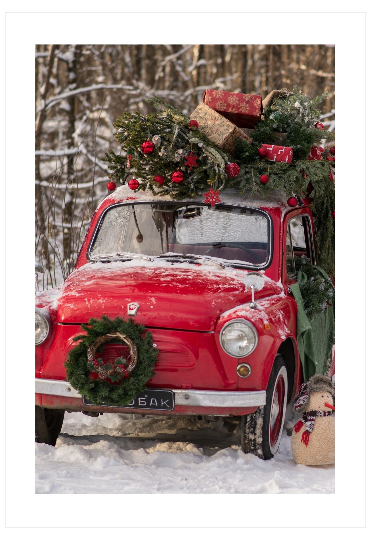 Red vintage car decorated with Christmas decorations in a snowy forest