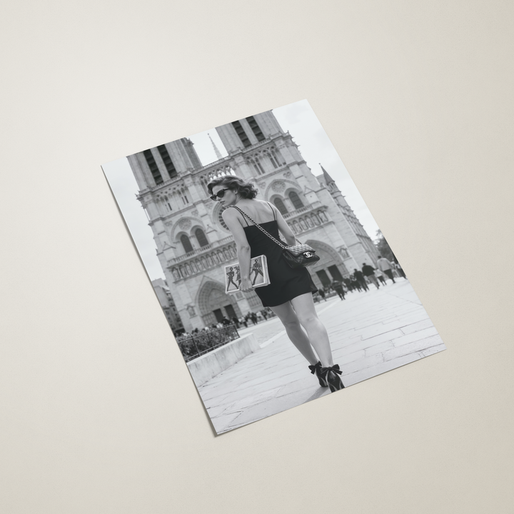 Poster with a black and white photography of a woman in a dress in Paris on a beige background