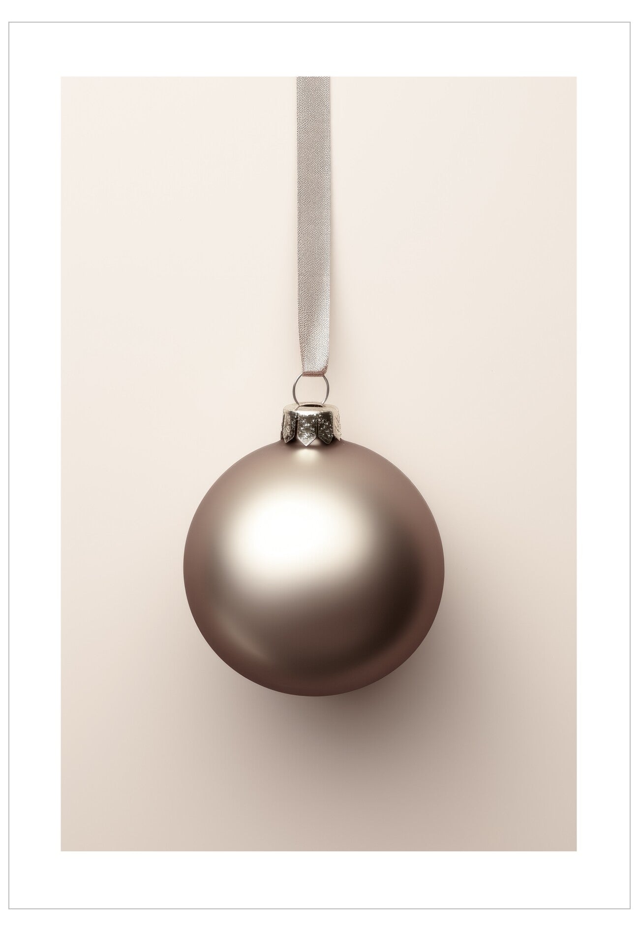 Bronze Christmas ball ornament hanging on a beige ribbon against a beige background
