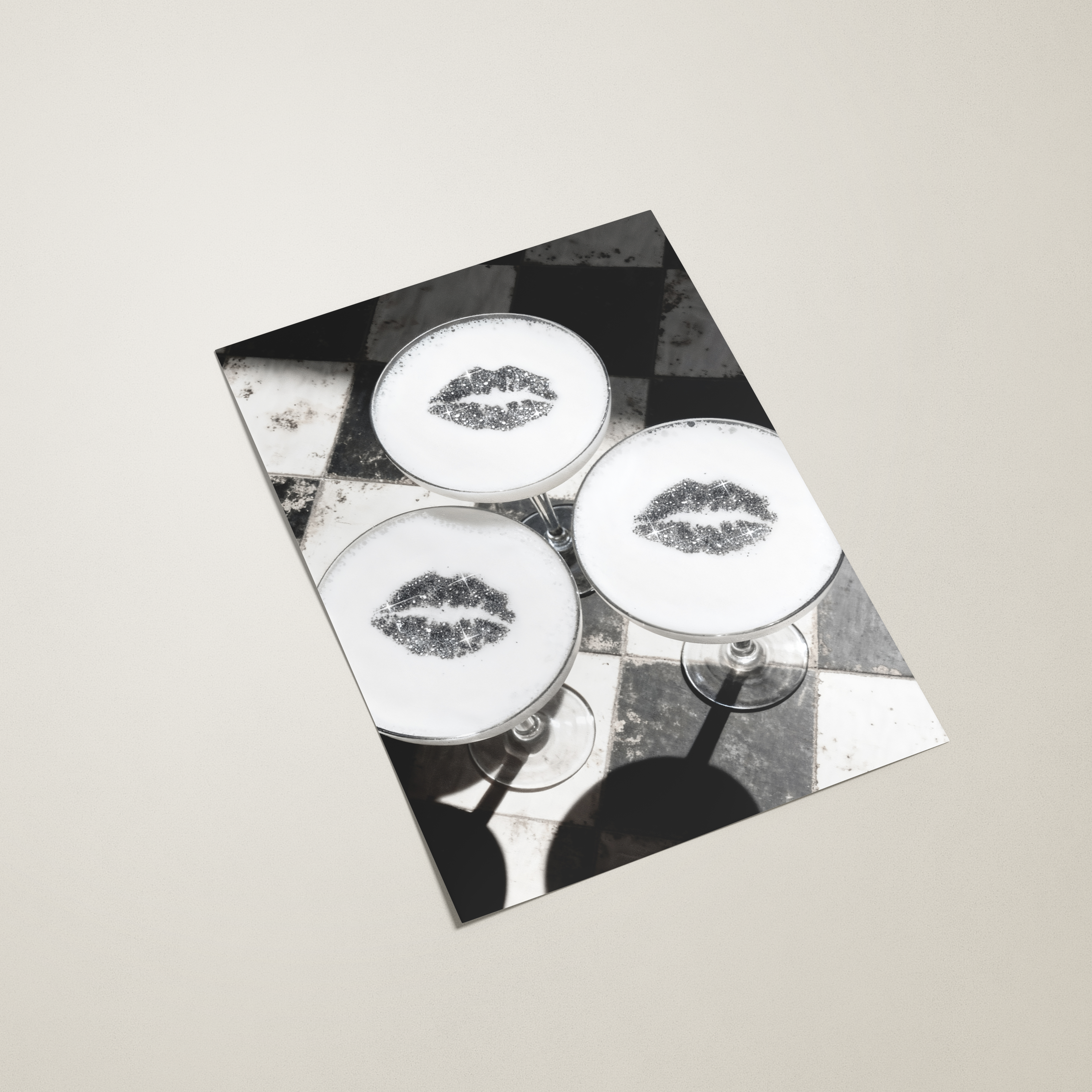 Black and white patterned paper with lip prints on a beige background