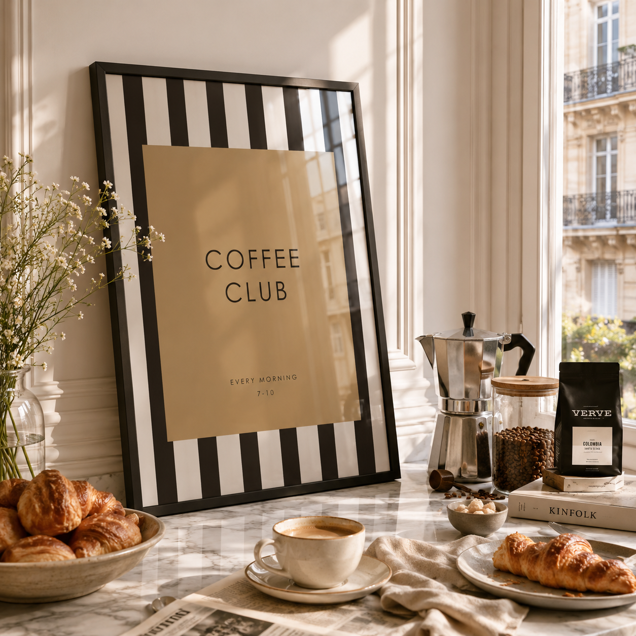 Coffee setup with 'Coffee Club' sign, coffee cup, pastries, and coffee maker in a bright room.