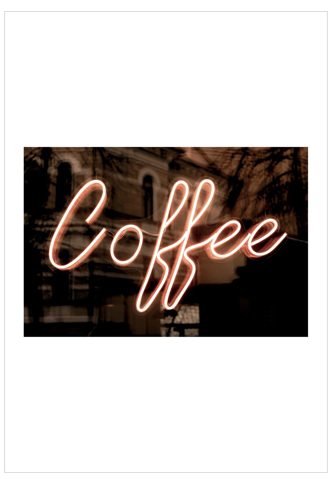 Neon sign spelling 'Coffee' in an urban setting