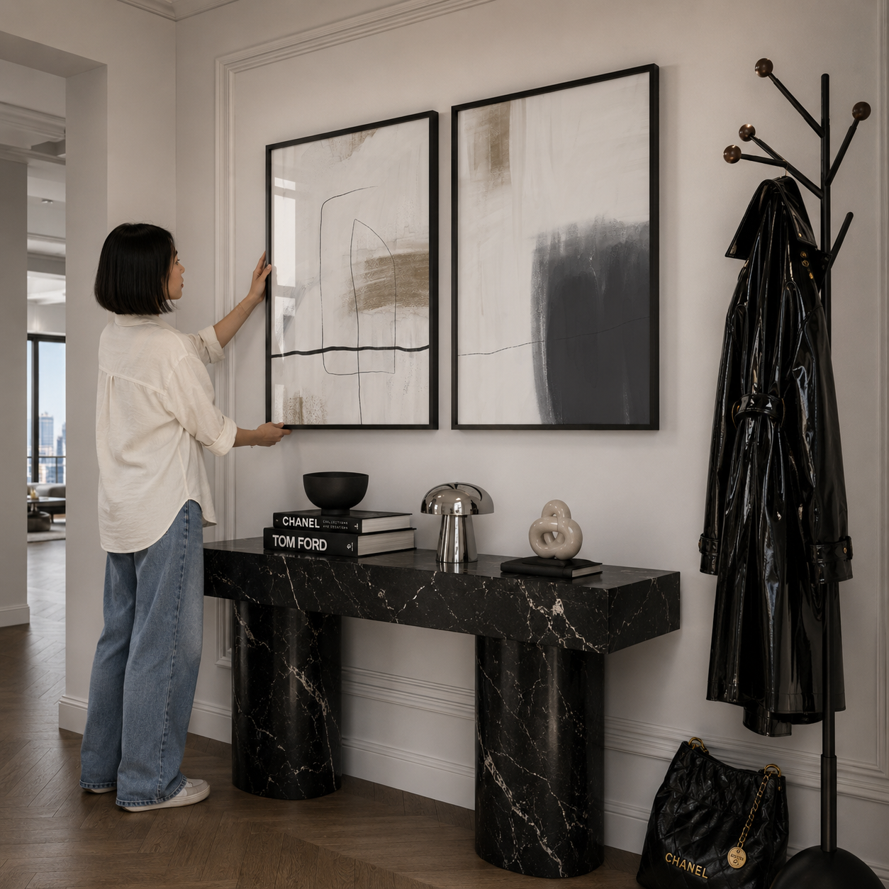 Woman arranging abstract art on a wall in a stylish interior setting.