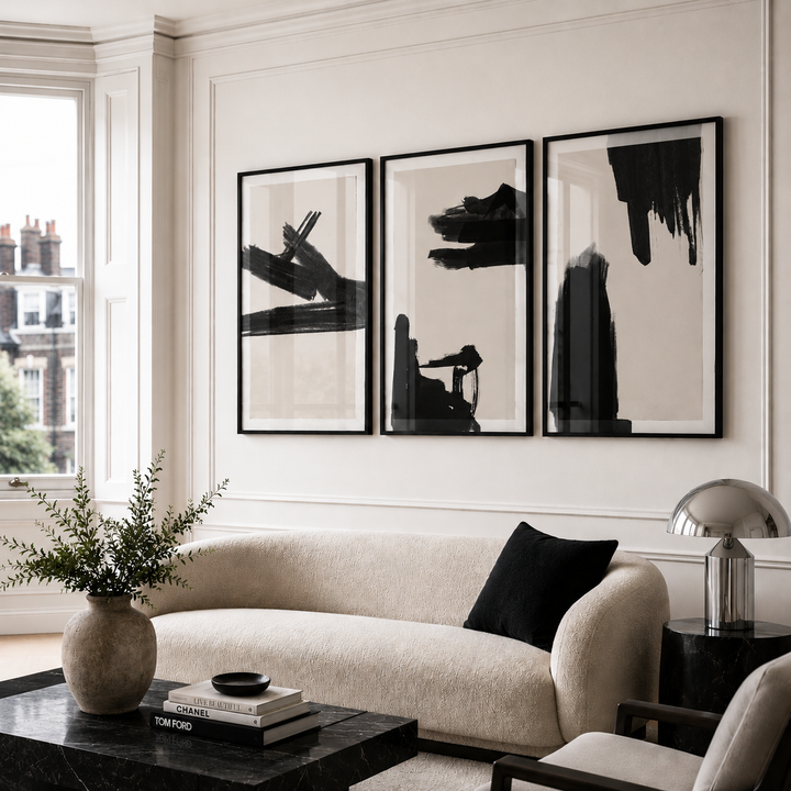 Modern living room with a beige sofa, abstract art, and decorative items.