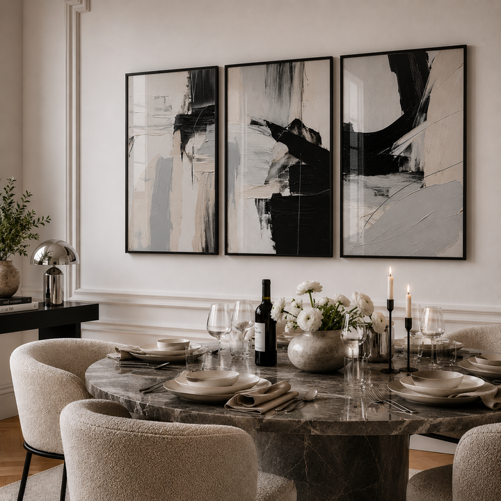 Elegant dining room with abstract art on the wall and a set table.