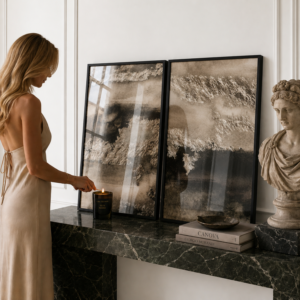 Woman lighting a candle next to framed artwork and a statue in a room with marble accents.