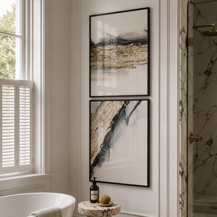Bathroom interior with framed abstract art on the wall, a bathtub, and marble shower.