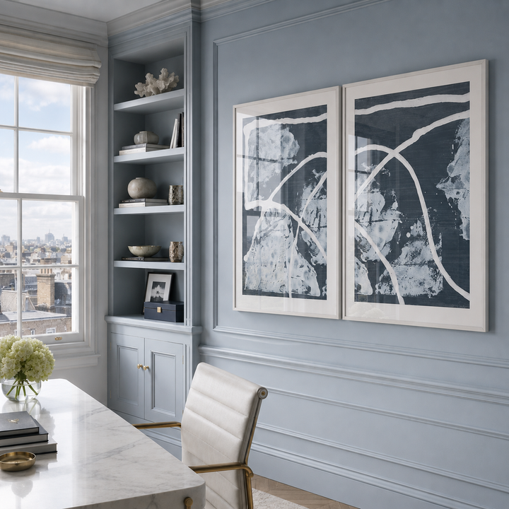 Modern office with gray walls, a desk, and abstract art.