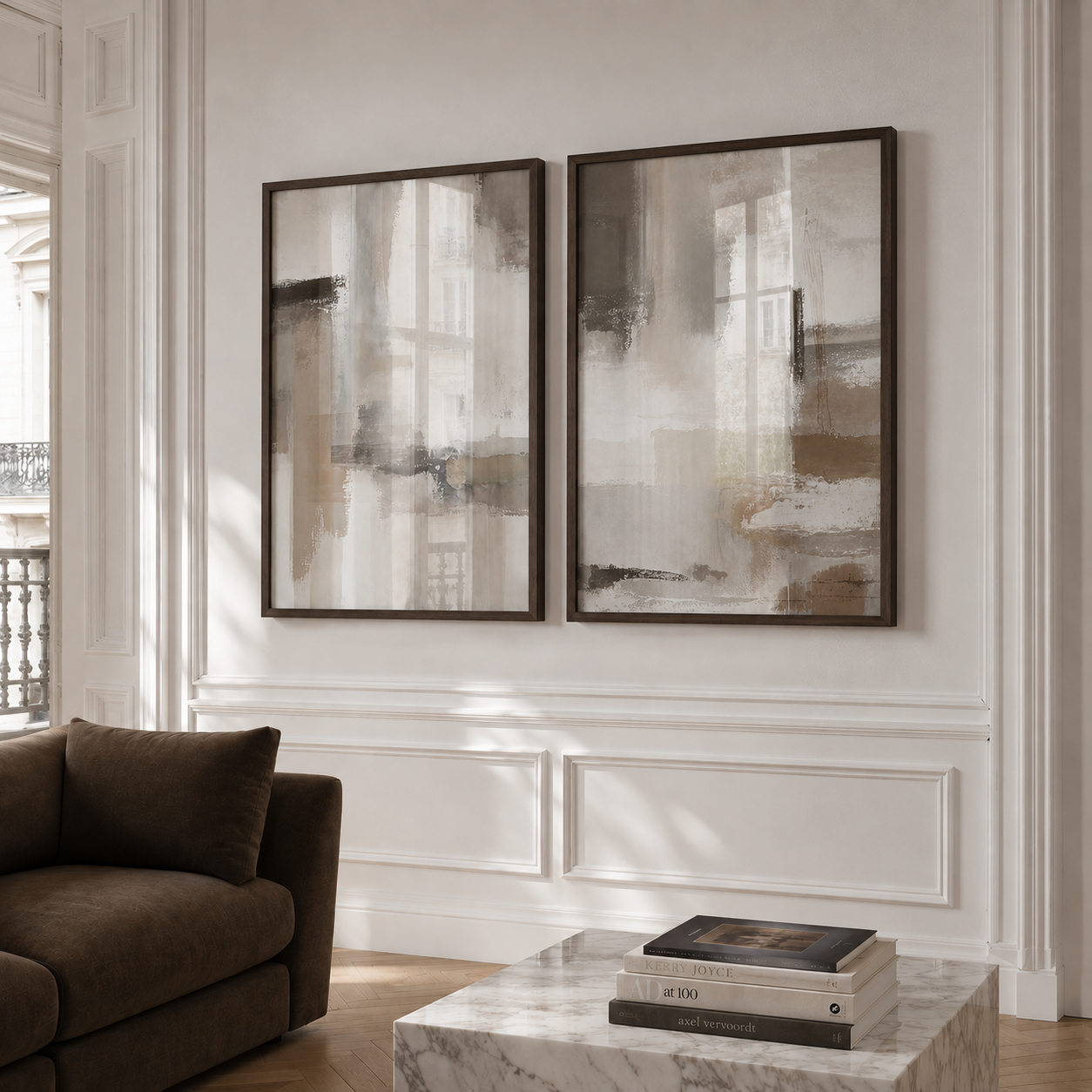 Two abstract paintings on a wall above a sofa in a living room.