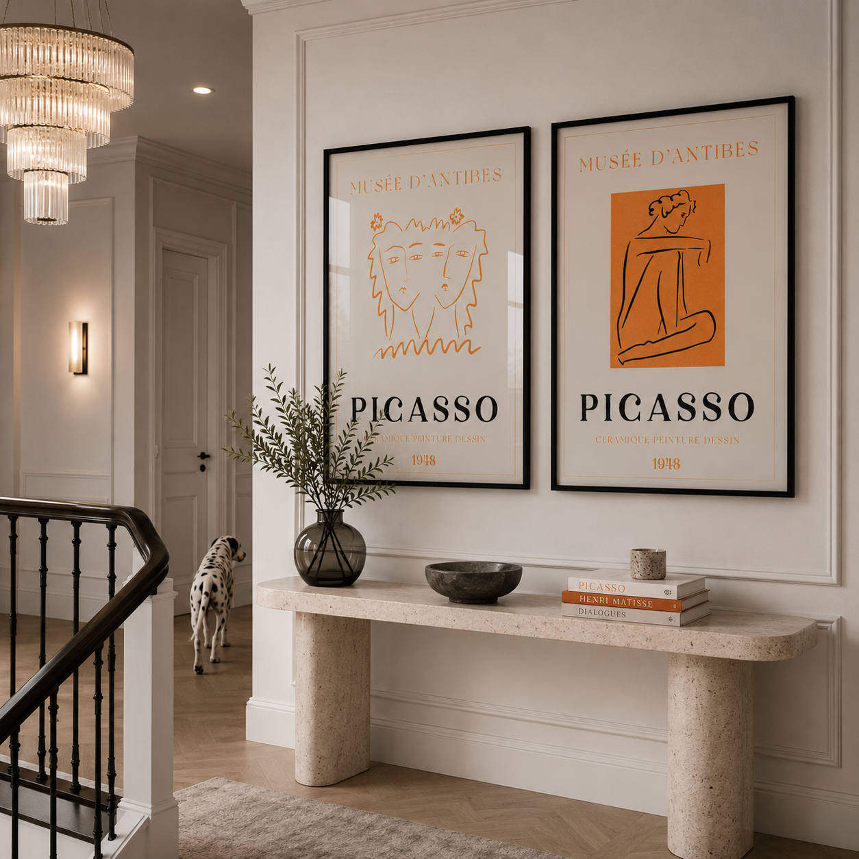 Staircase with a console table featuring Picasso art prints and a dalmation dog in a hallway.