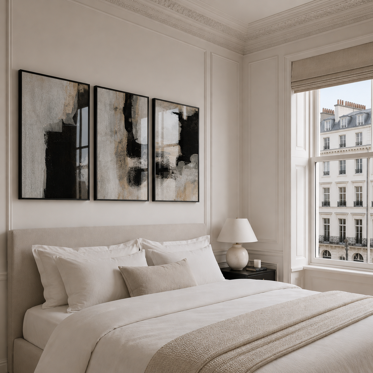 Neatly made bed in a bedroom with abstract art on the wall and a cityscape view through the window.